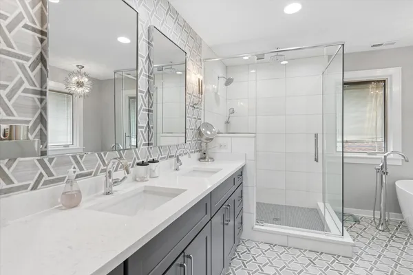 a bathroom with a shower sink vanity and mirror