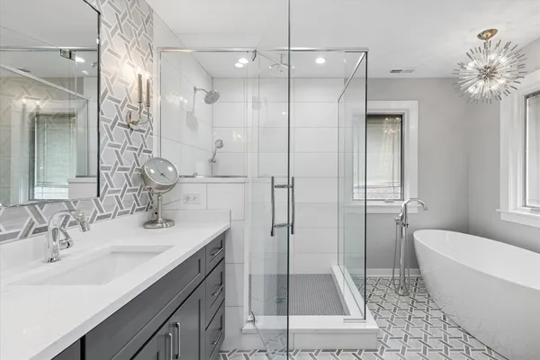 a bathroom with a sink a toilet and shower