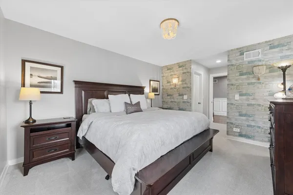 a bed room with a bed and a lamp