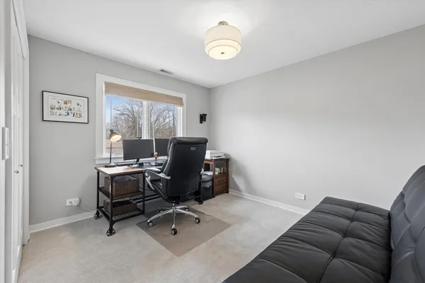 a livingroom with workspace and a window