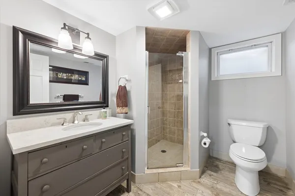a bathroom with a toilet sink and shower