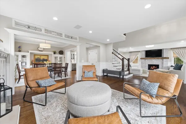 a living room with furniture and a view of kitchen