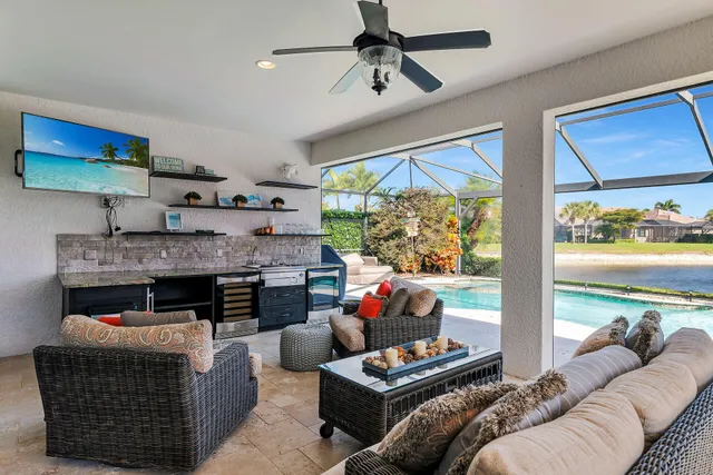 a view of a backyard with table and chairs under an umbrella