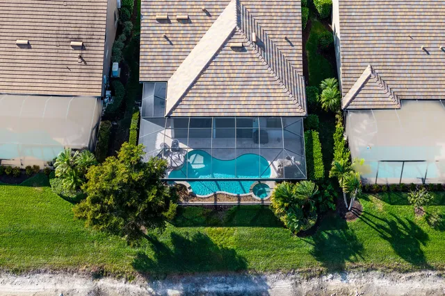 an aerial view of a house with a swimming pool yard and outdoor seating