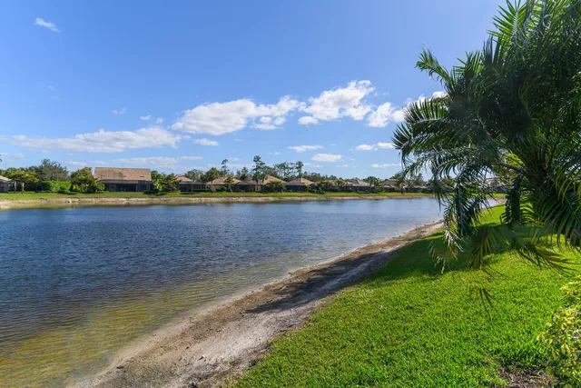a living room with patio furniture and a large window