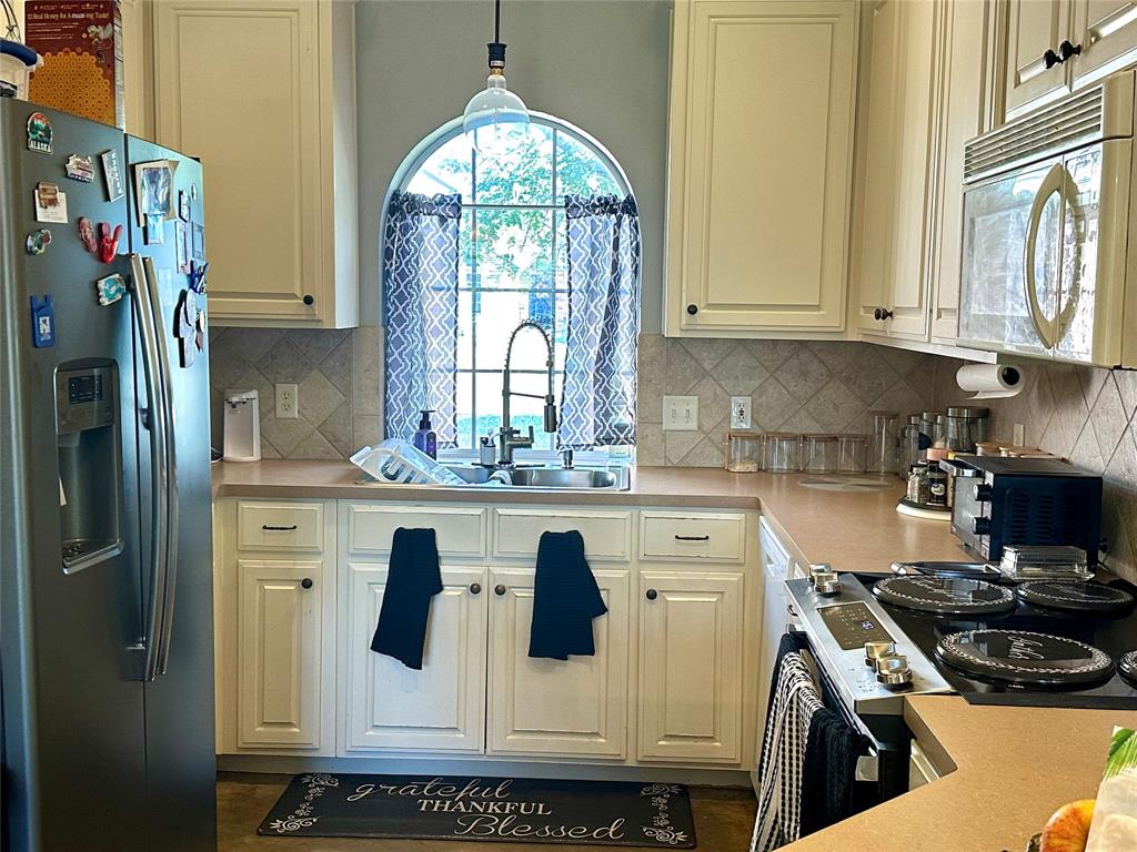 10504 Whitney Trace Drive Waco, TX 76708 - Photo 11 of 36 a kitchen with stainless steel appliances granite countertop a stove a sink and a refrigerator