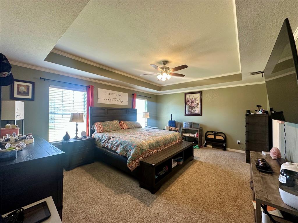 10504 Whitney Trace Drive Waco, TX 76708 - Photo 13 of 36 a spacious bedroom with a bed and wooden floor