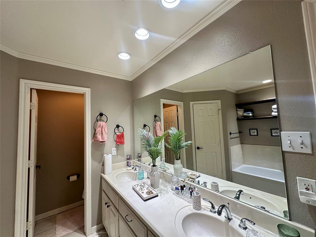 10504 Whitney Trace Drive Waco, TX 76708 - Photo 16 of 36 a en suite bathroom with a double vanity sink and a mirror