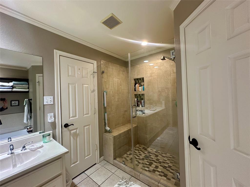 10504 Whitney Trace Drive Waco, TX 76708 - Photo 17 of 36 a bathroom with a sink a toilet a shower and a mirror