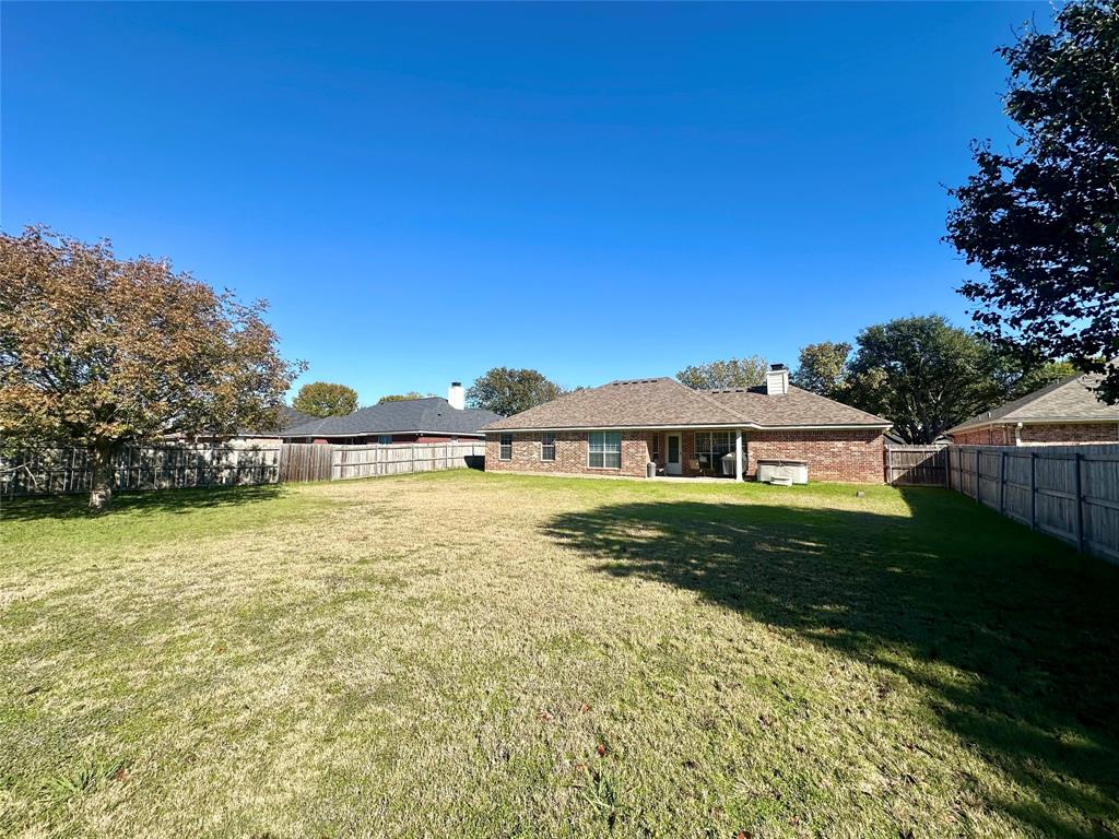 10504 Whitney Trace Drive Waco, TX 76708 - Photo 30 of 36 a view of a house with garden and a yard