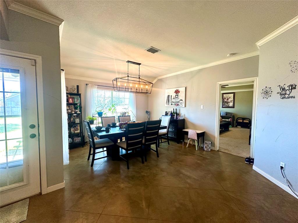 10504 Whitney Trace Drive Waco, TX 76708 - Photo 8 of 36 a dining room with furniture and a chandelier