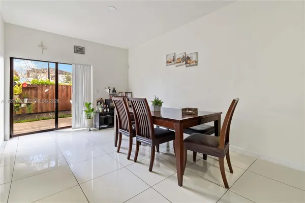 a view of a dining room with furniture and floor to ceiling window