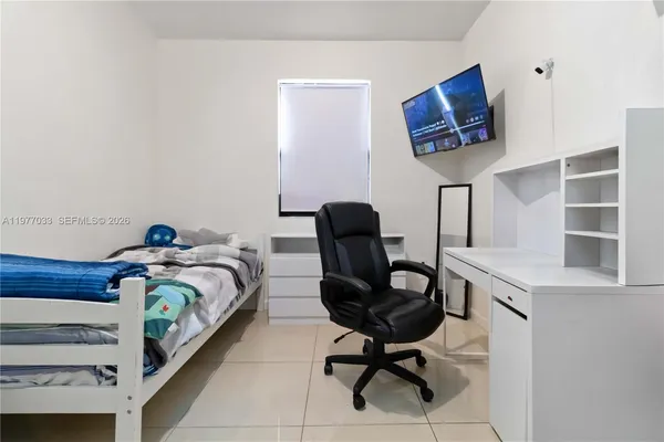 a bedroom with a bed and a chair
