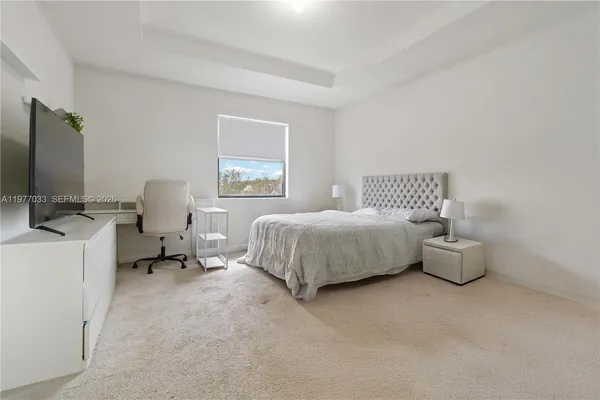 a bedroom with a bed and a desk
