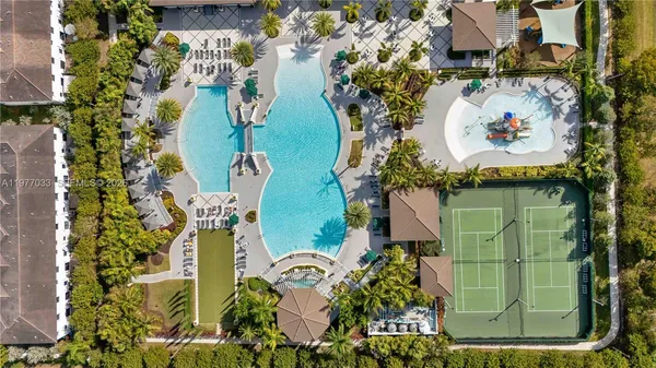 an aerial view of a residential houses with outdoor space