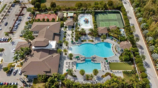 an aerial view of a house with yard swimming pool and outdoor seating