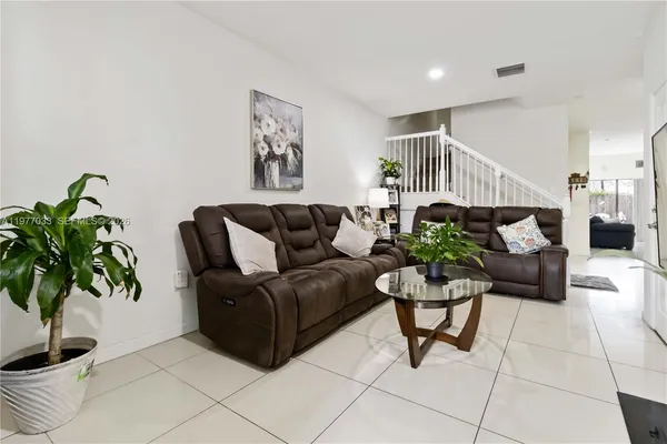 a living room with furniture plant and a potted plant