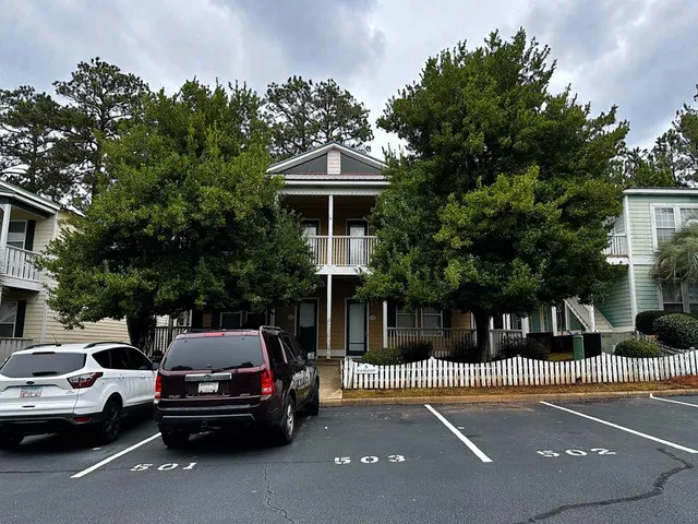 a view of a car parked in front of a house