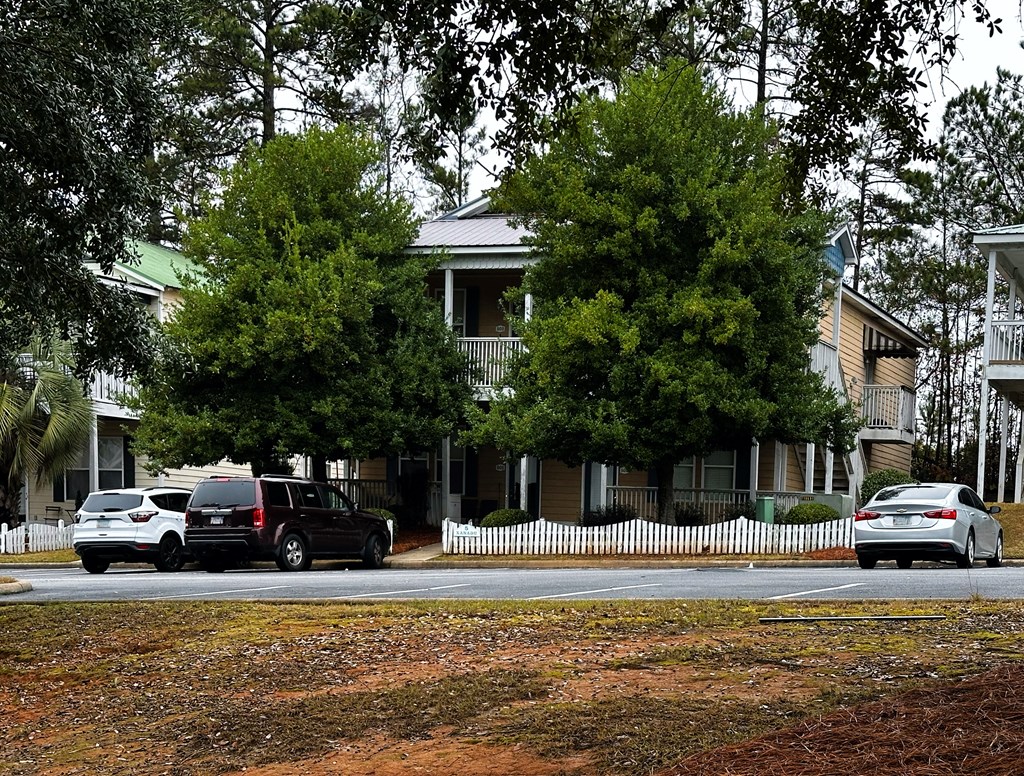 8082 Veterans Parkway, Unit 5 Columbus, GA 31909 - Photo 2 of 7 a front view of a house with a garden and car parked