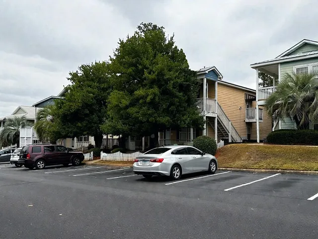 a view of cars parked on the side of a street