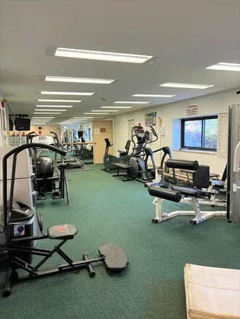 a room with gym equipment and a flat screen tv