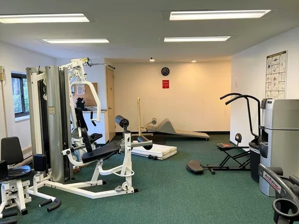 a room with gym equipment and a large window