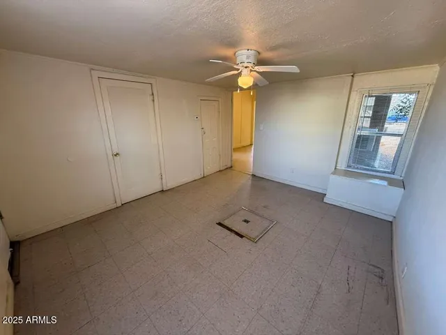 an empty room with windows and entrance