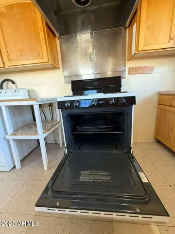a stove top oven sitting inside of a kitchen