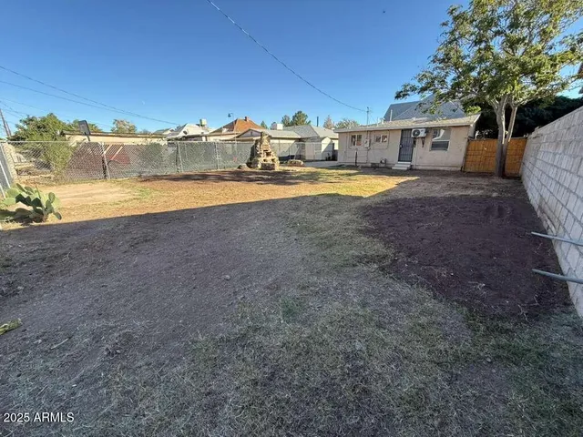 a view of a house with swimming pool and sitting area