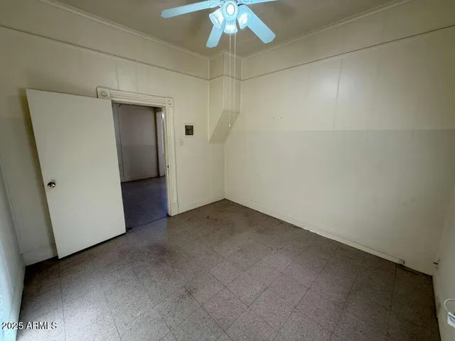 a view of a room with a chandelier fan and closet