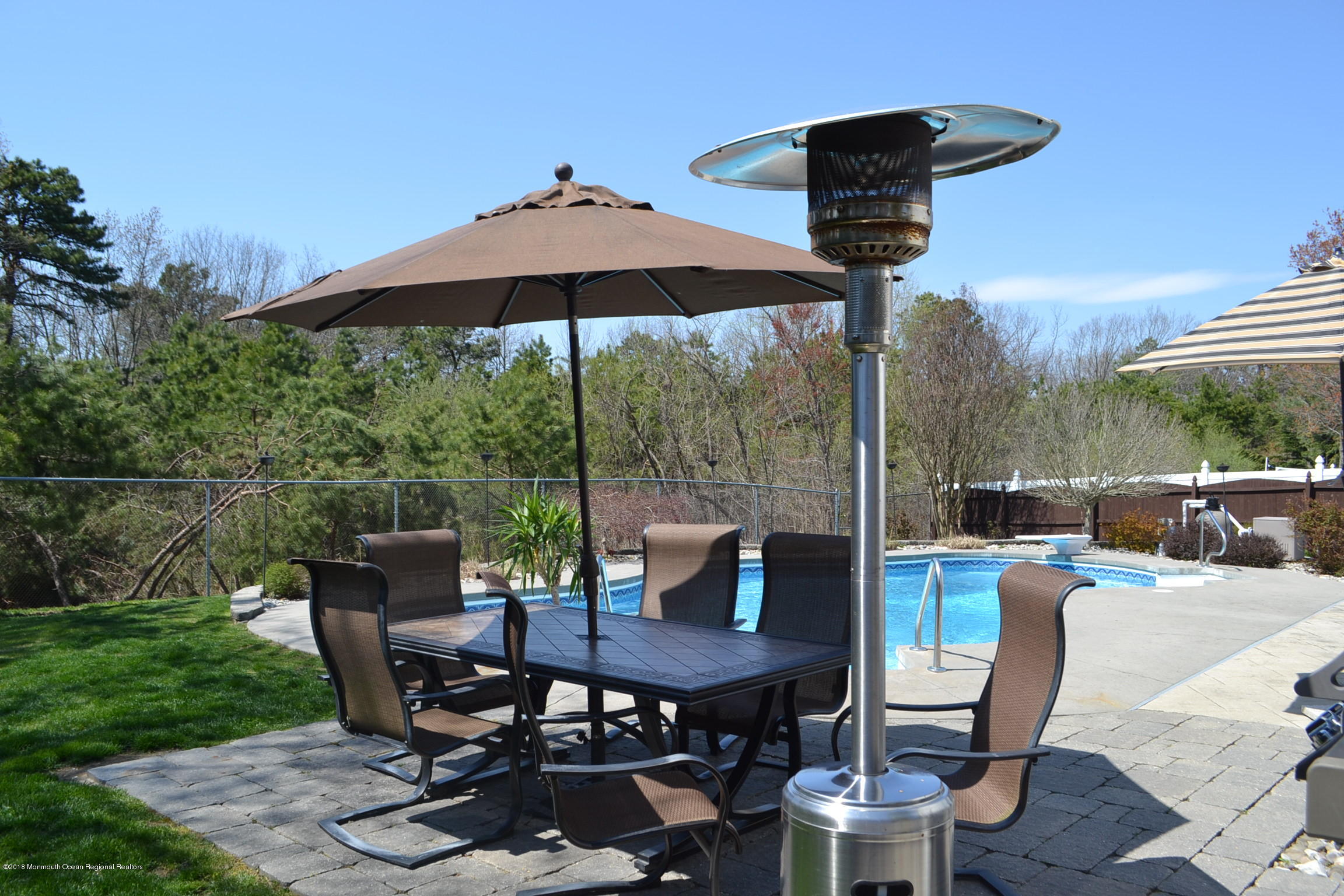 30 Netty Street Howell, NJ 07731 - Photo 23 of 24 a view of a patio with table and chairs under an umbrella
