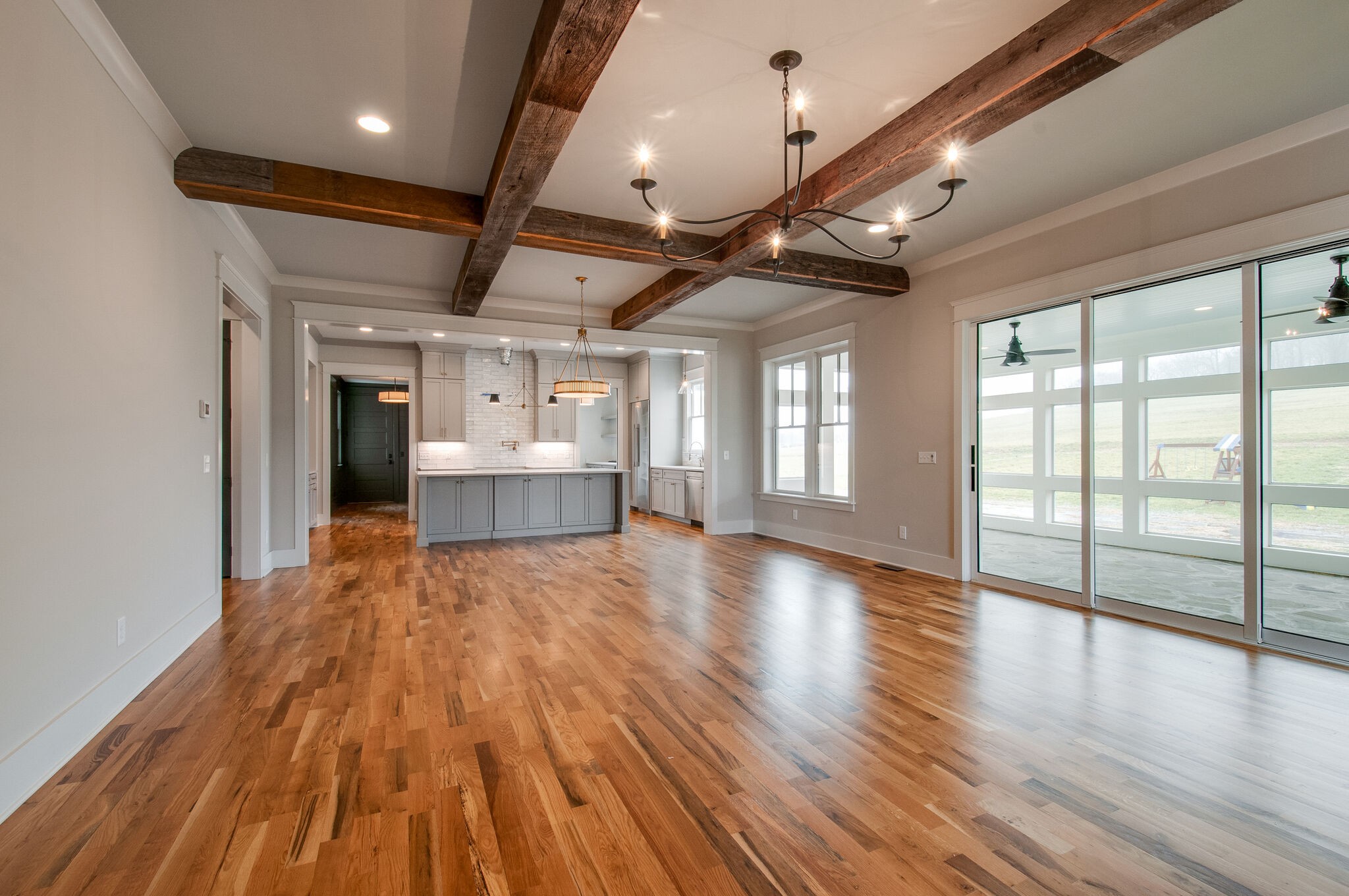 4510 Harpeth School Road Franklin, TN 37064 - Photo 14 of 43 a view of an empty room with wooden floor and a kitchen