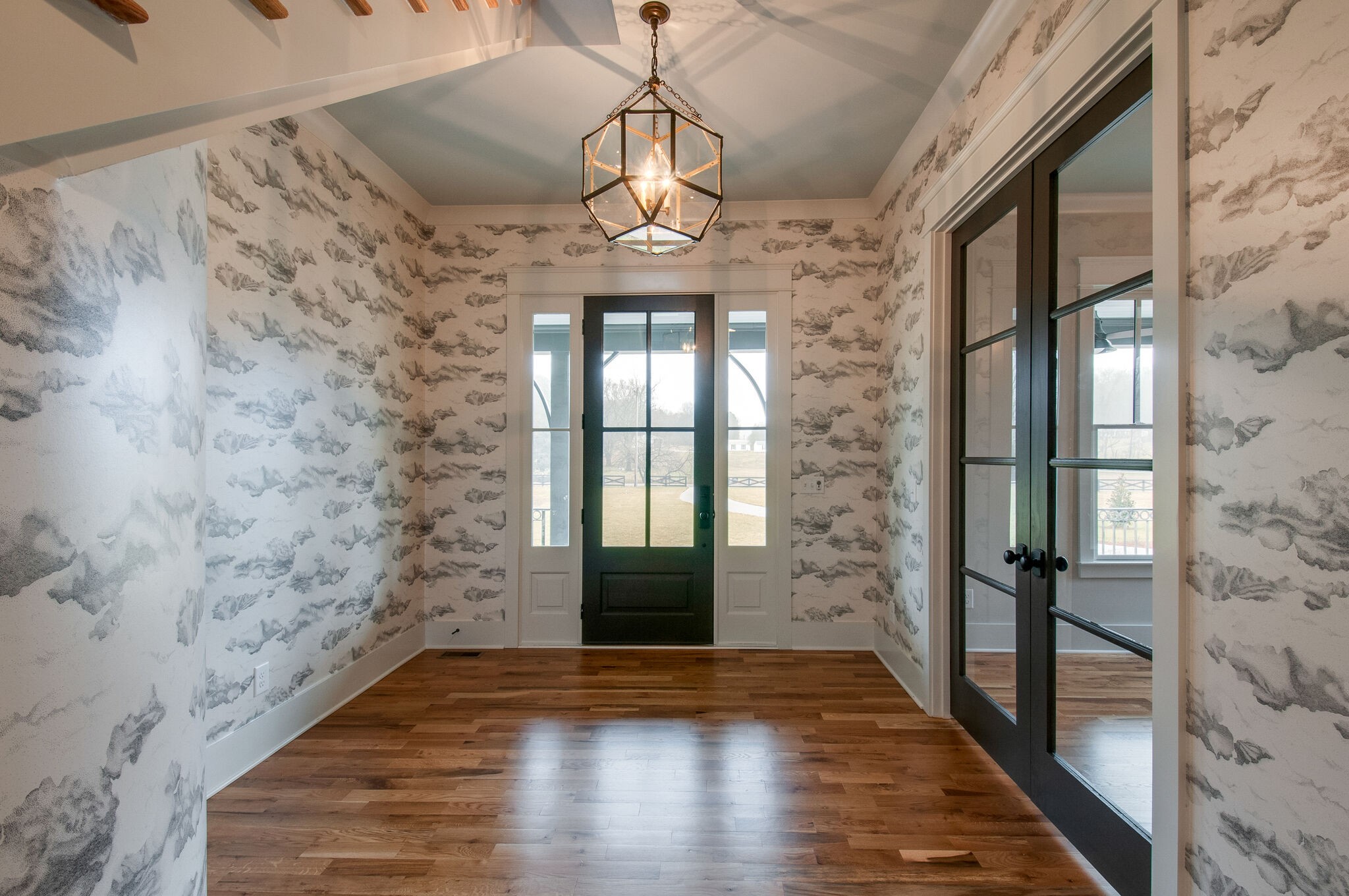 4510 Harpeth School Road Franklin, TN 37064 - Photo 6 of 43 a view of hallway with wooden floor and chandelier