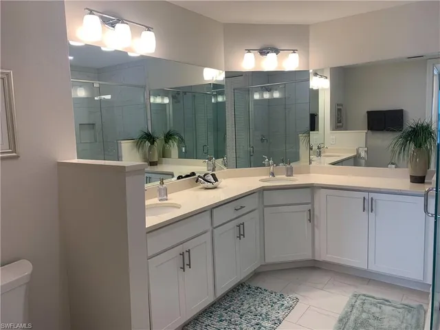 a bathroom with a double vanity sink and a mirror