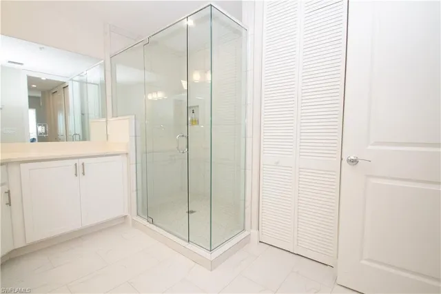 a bathroom with a glass shower door