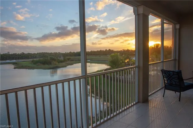 a view of a balcony with lake view and wooden floor