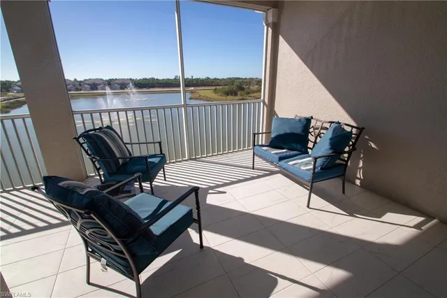 a view of a roof deck with furniture