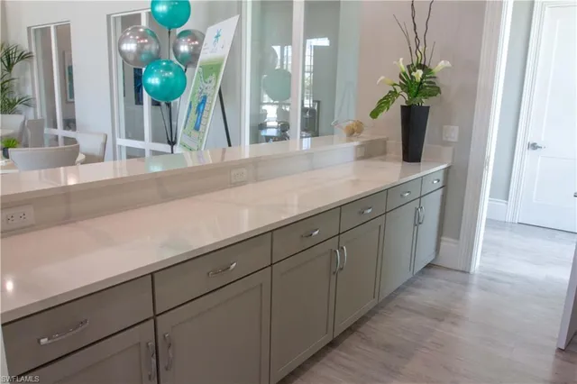 a bathroom with a granite countertop sink a potted plant and a shower