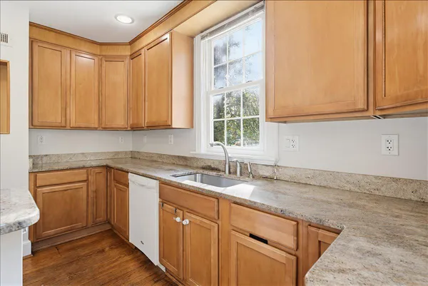 a view of walk in closet with wooden floor