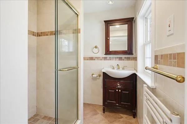 a bathroom with a sink a toilet and shower