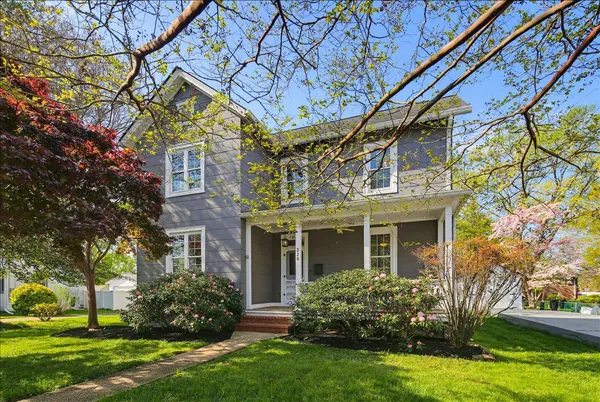 a view of a porch with a table chairs and a yard