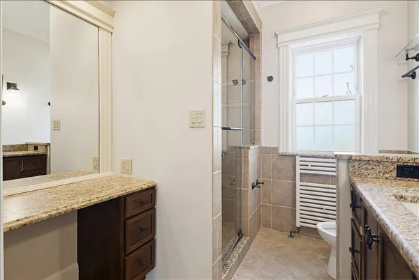 a front view of a house with a garden and yard