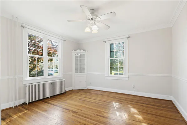 a view of a hallway with wooden floor and closet
