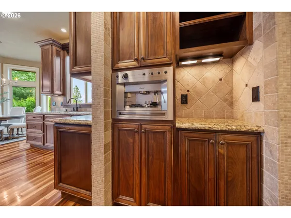a kitchen with stainless steel appliances kitchen island granite countertop a stove a sink and a microwave