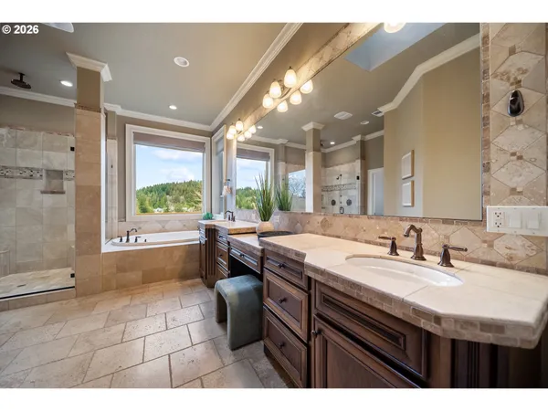 a bathroom with a sink a large mirror and a bathtub