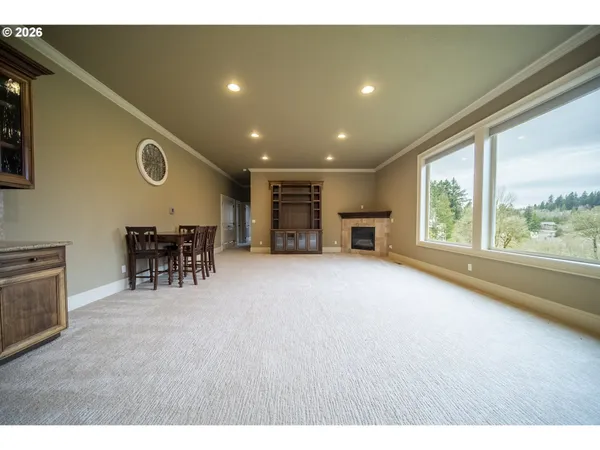 a view of an empty room with furniture and a window