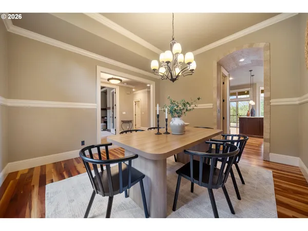 a view of a dining room with furniture and chandelier