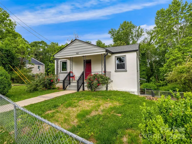 a view of a house with a yard patio and a garden