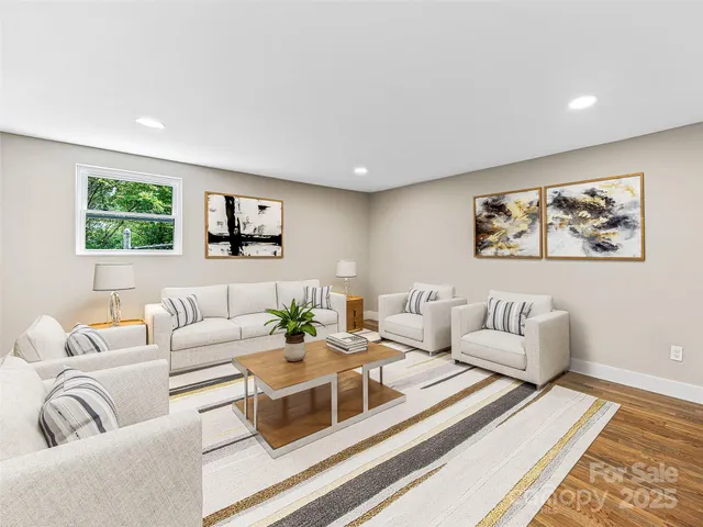 a living room with furniture and painting on the wall