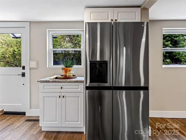 a kitchen with stainless steel appliances granite countertop a refrigerator and a sink